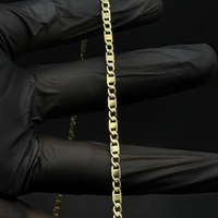 Cadena espejo delgada de El Rey Joyero en oro laminado 18k con eslabones planos y brillantes sobre fondo negro