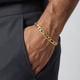 Pulsera tipo Cartier Figaro de 7mm en oro laminado 18k de El Rey Joyero, lucida en la muñeca de un hombre.