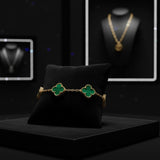 Pulsera El Rey Joyero estilo trébol con detalles en verde y oro laminado 18k sobre cojín negro